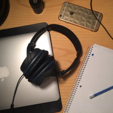 headphones, laptop, graph paper on table